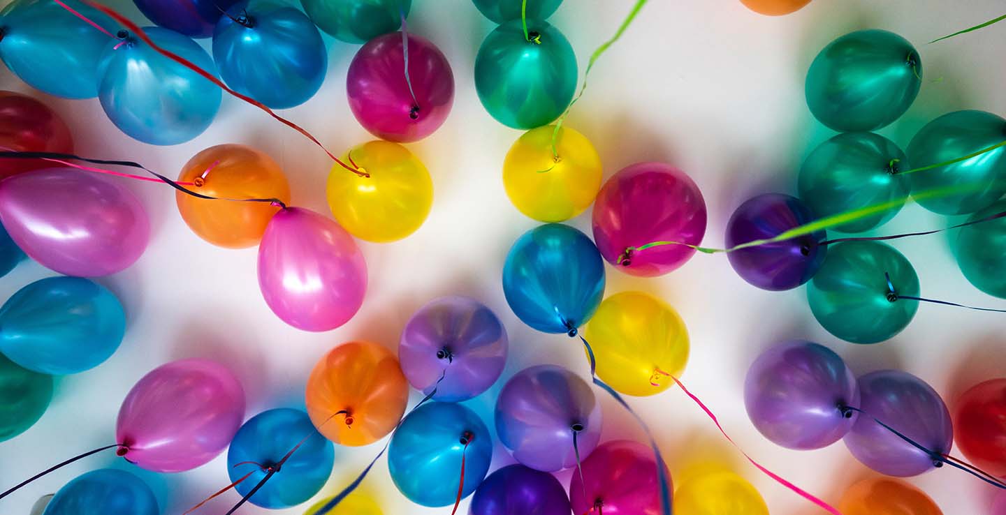 colourful balloons at top of ceiling